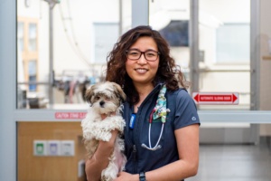 veterinary technician holding small dog